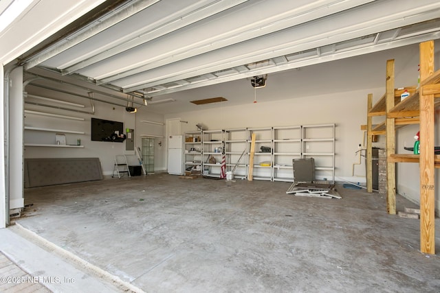 garage with a garage door opener and electric panel