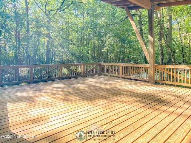wooden deck with a view of trees