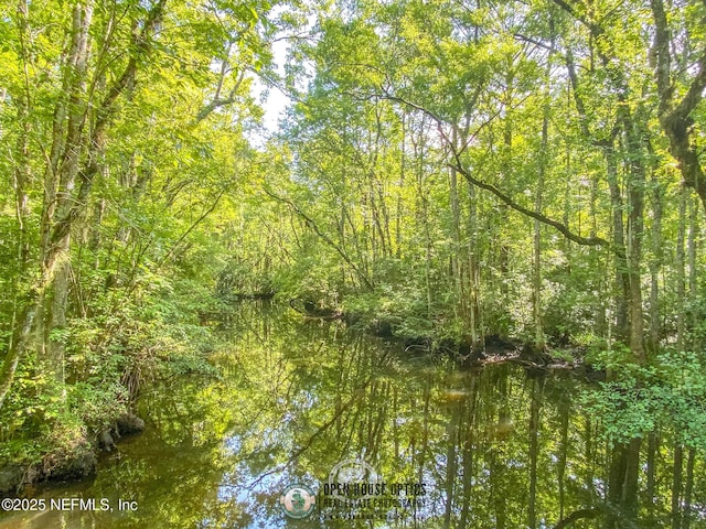 view of landscape featuring a forest view