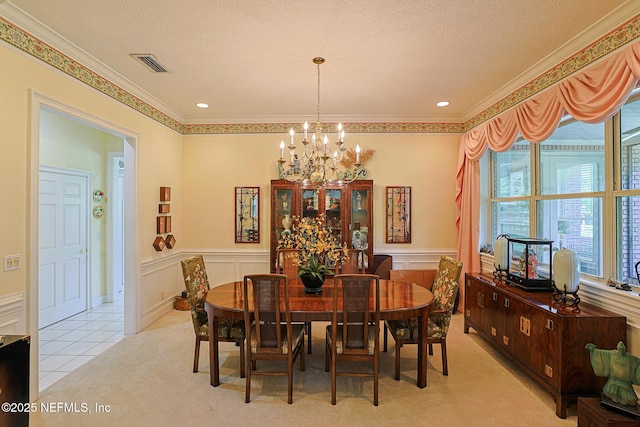 3666 Cypress Point Ct, Green Cove Springs, FL 32043 - dining area featuring a chandelier, crown molding, wainscoting, a textured ceiling, and a decorative wall