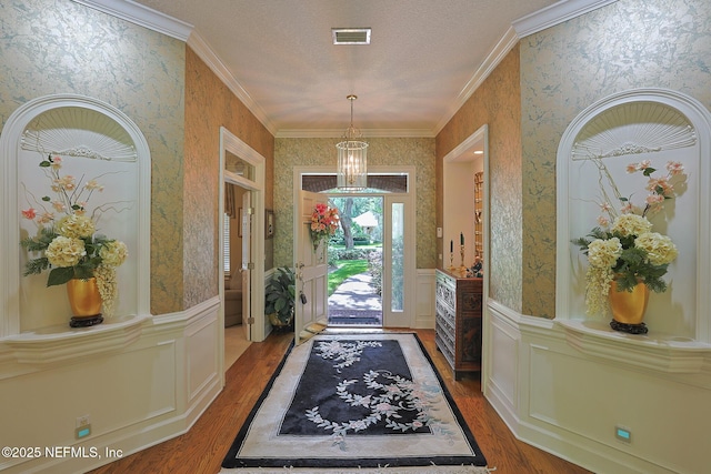 3666 Cypress Point Ct, Green Cove Springs, FL 32043 - entrance foyer featuring wallpapered walls, wood finished floors, crown molding, wainscoting, and a decorative wall