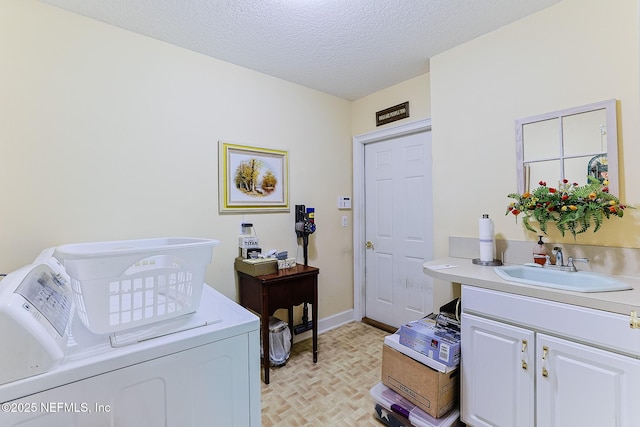 3666 Cypress Point Ct, Green Cove Springs, FL 32043 - clothes washing area with washer and clothes dryer, cabinet space, a textured ceiling, and baseboards