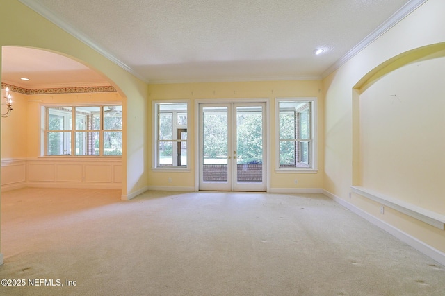 3666 Cypress Point Ct, Green Cove Springs, FL 32043 - carpeted spare room featuring french doors, crown molding, a textured ceiling, and arched walkways