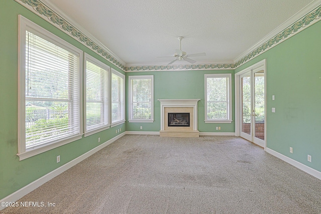 3666 Cypress Point Ct, Green Cove Springs, FL 32043 - unfurnished living room featuring a ceiling fan, a textured ceiling, crown molding, healthy amount of natural light, and carpet flooring