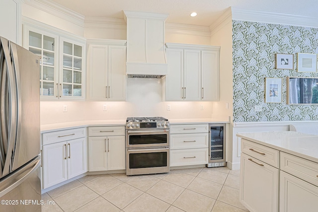 kitchen featuring stainless steel appliances, wine cooler, custom exhaust hood, light countertops, and white cabinets