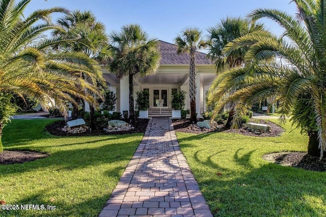 view of front facade with a front lawn and french doors