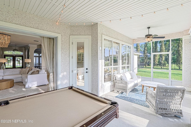 sunroom / solarium featuring ceiling fan, billiards table, and outdoor lounge area