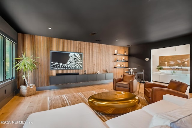 cinema with recessed lighting, wood walls, and wood finished floors