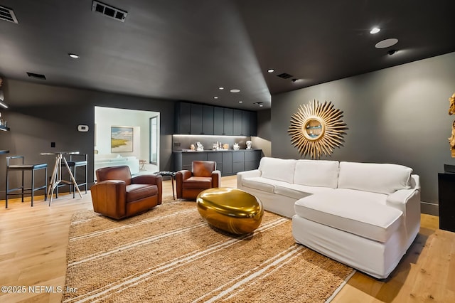 cinema with recessed lighting, baseboards, visible vents, and light wood-type flooring