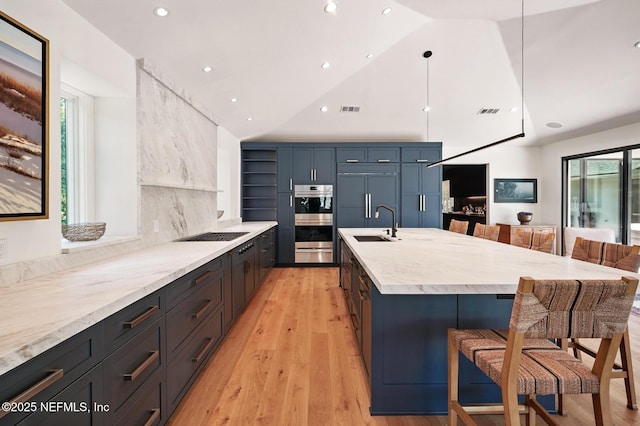 kitchen featuring open shelves, stainless steel double oven, a sink, a kitchen bar, and a warming drawer