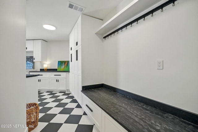 mudroom with dark floors and visible vents