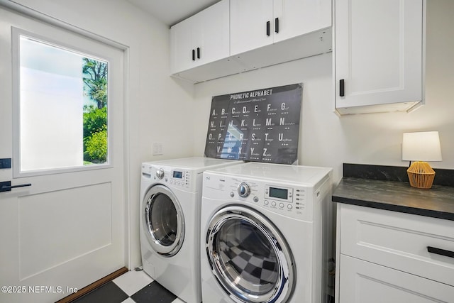 laundry room featuring plenty of natural light, cabinet space, and washer and clothes dryer