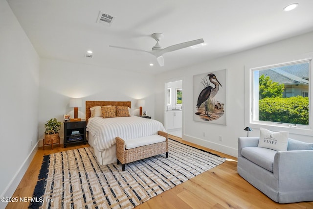 bedroom with visible vents, wood finished floors, baseboards, connected bathroom, and recessed lighting