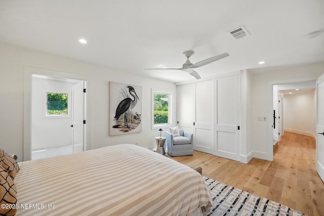 bedroom featuring a ceiling fan, visible vents, a closet, light wood-style floors, and recessed lighting