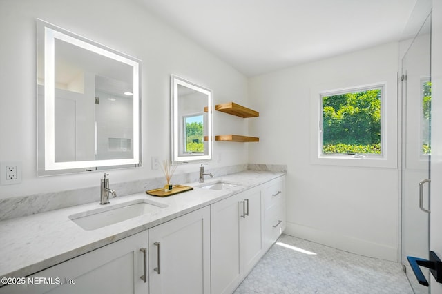 kitchen with a sink, open shelves, white cabinets, and light stone countertops