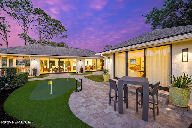 patio terrace at dusk featuring outdoor dining area