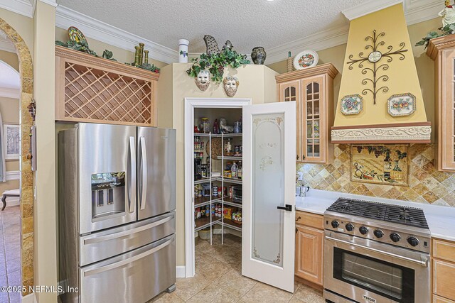 3593 Long Cove Ct, Green Cove Springs, FL 32043 - kitchen featuring glass insert cabinets, stainless steel appliances, backsplash, light countertops, and light tile patterned flooring