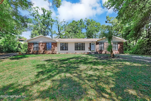 single story home featuring brick siding and a front lawn