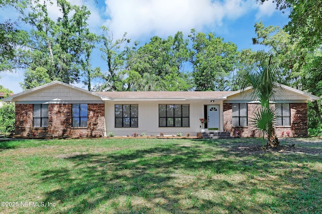 ranch-style home featuring brick siding and a front lawn