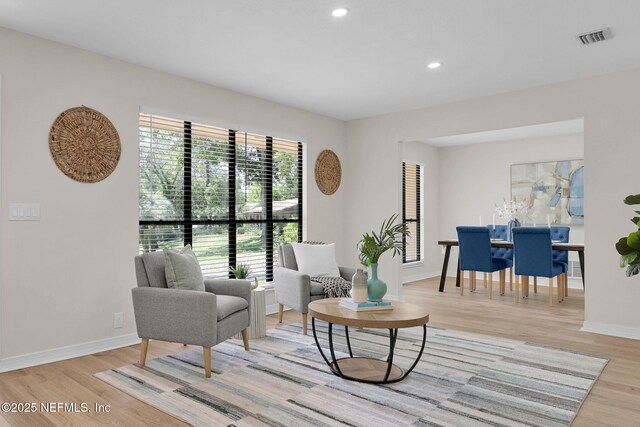 sitting room featuring visible vents, recessed lighting, light wood-style flooring, and baseboards
