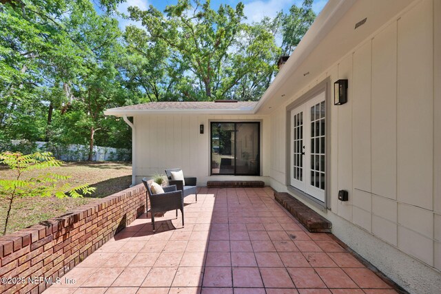 view of patio / terrace featuring fence and french doors