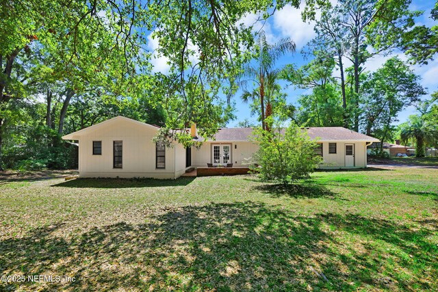 view of front of property featuring french doors and a front lawn