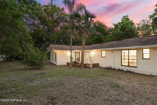 view of back of property at dusk
