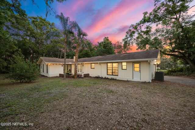 single story home featuring central air condition unit