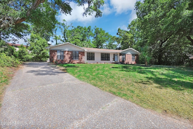 ranch-style house with a front yard, driveway, and brick siding