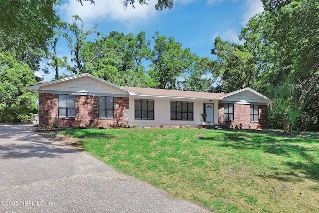 ranch-style home with aphalt driveway, a front lawn, and brick siding
