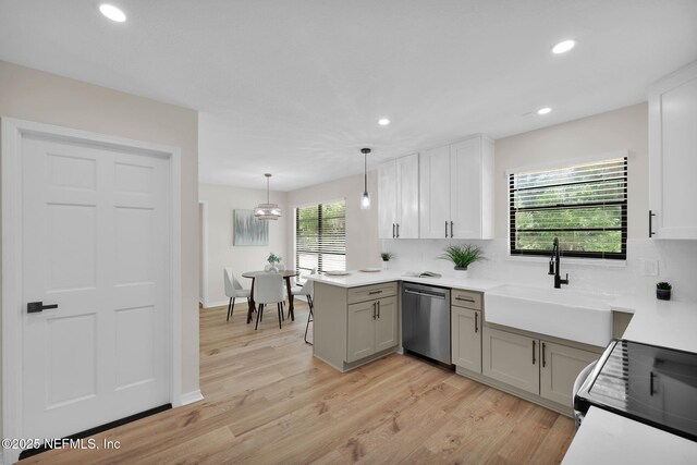 kitchen with light countertops, recessed lighting, tasteful backsplash, and dishwasher