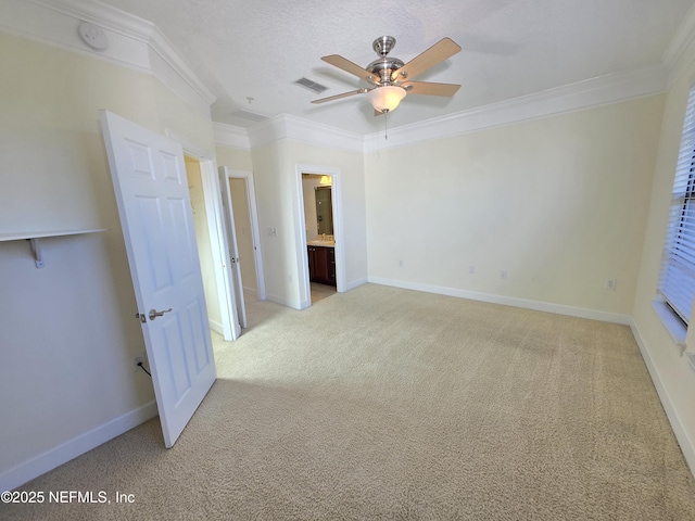 unfurnished room with crown molding, a ceiling fan, baseboards, and light colored carpet