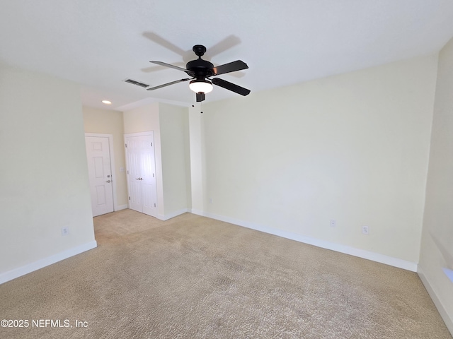 empty room featuring ceiling fan, light colored carpet, recessed lighting, baseboards, and visible vents