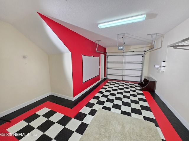 garage with baseboards and a garage door opener