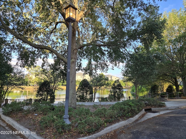 exterior space featuring a water view and fence