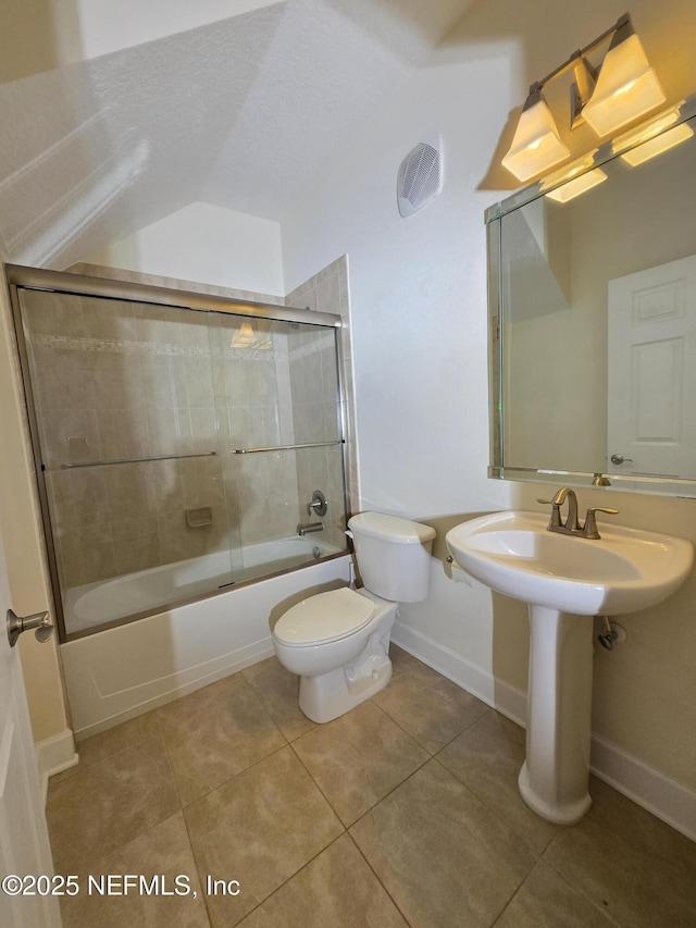 full bathroom featuring tile patterned flooring, a sink, baseboards, toilet, and enclosed tub / shower combo