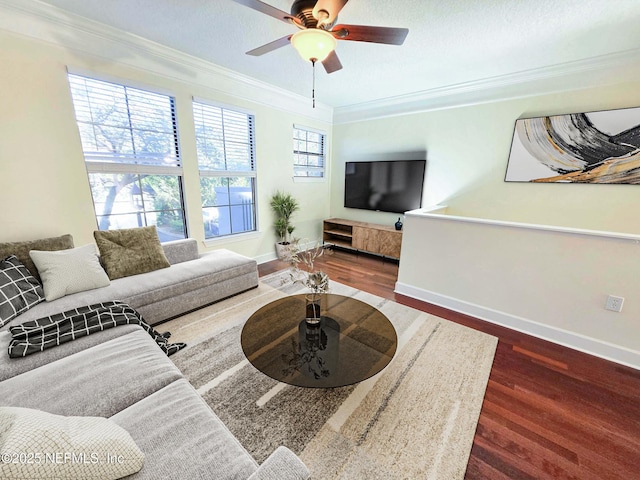 living room with crown molding, baseboards, ceiling fan, and wood finished floors