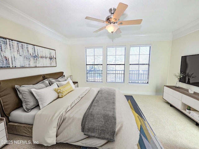 bedroom featuring crown molding, carpet flooring, baseboards, and ceiling fan