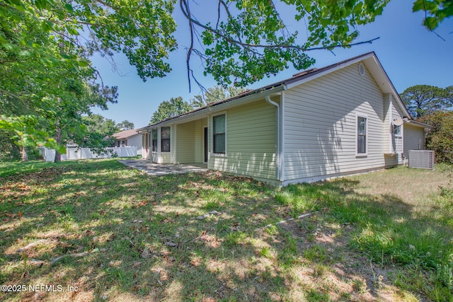 1742 Tiffany Pines Cir E, Jacksonville, FL 32225 - back of house with a lawn, fence, central AC unit, and a patio area