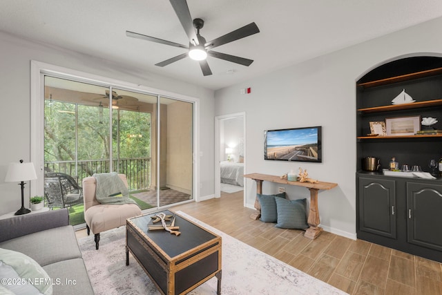 8601 Beach Blvd Unit 323, Jacksonville, FL 32216 - living area with baseboards, light wood-style flooring, and ceiling fan