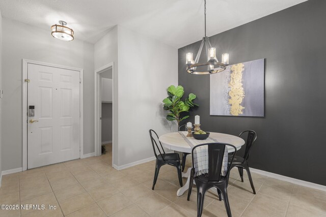 8601 Beach Blvd Unit 323, Jacksonville, FL 32216 - dining space featuring an inviting chandelier, baseboards, and light tile patterned flooring