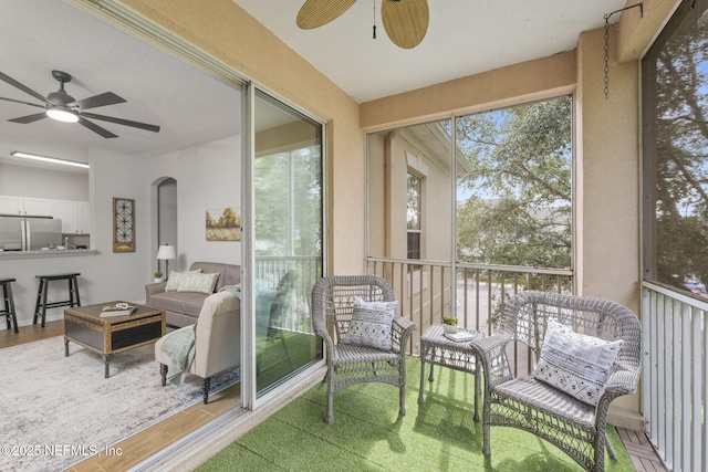8601 Beach Blvd Unit 323, Jacksonville, FL 32216 - sunroom with arched walkways, outdoor lounge area, and a ceiling fan