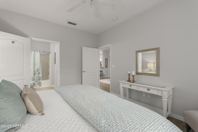 8601 Beach Blvd Unit 323, Jacksonville, FL 32216 - bedroom with visible vents, wood finished floors, baseboards, ceiling fan, and connected bathroom