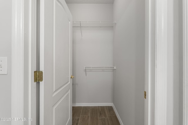 8601 Beach Blvd Unit 323, Jacksonville, FL 32216 - walk in closet featuring dark wood-style floors