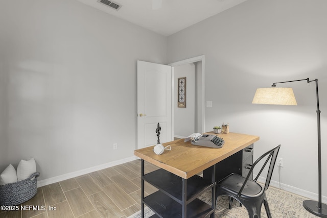 8601 Beach Blvd Unit 323, Jacksonville, FL 32216 - home office with visible vents, baseboards, and wood finished floors