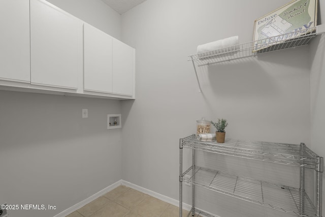 8601 Beach Blvd Unit 323, Jacksonville, FL 32216 - clothes washing area with baseboards, hookup for a washing machine, cabinet space, and light tile patterned floors