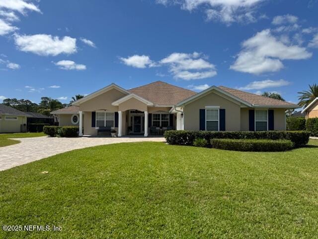 view of front facade featuring stucco siding and a front lawn
