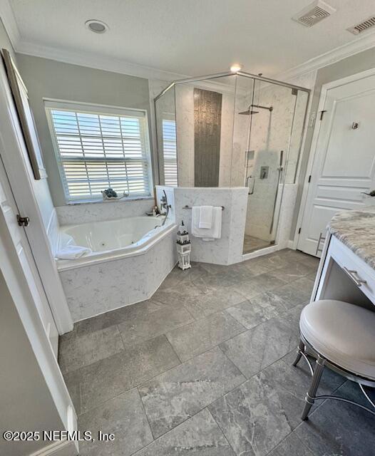 full bath featuring visible vents, ornamental molding, vanity, a jetted tub, and a shower stall