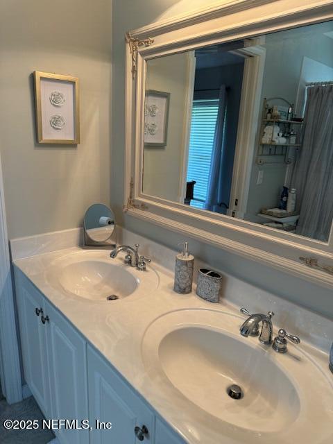 bathroom featuring double vanity and a sink
