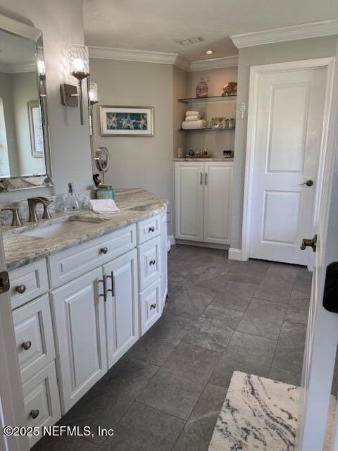bathroom with vanity and ornamental molding